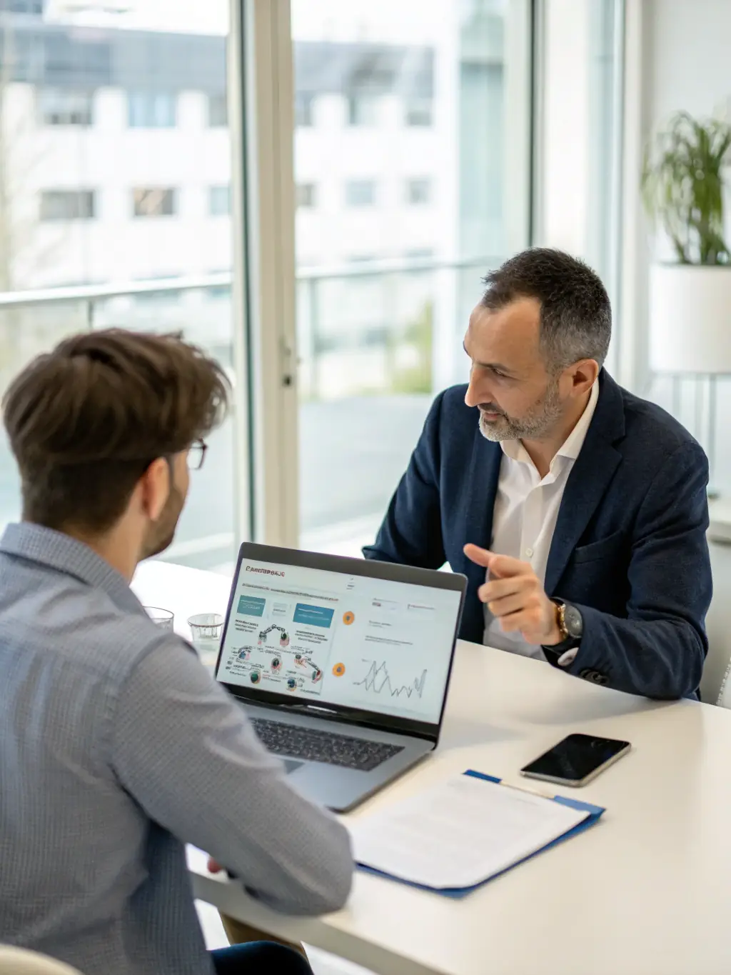A professional consultant discussing IT strategies with a client in a modern office setting, emphasizing collaboration and problem-solving.